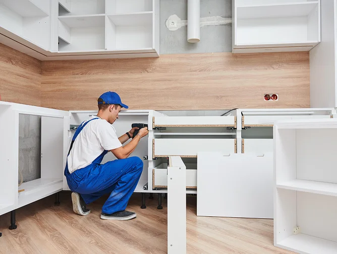 Contractor staging new kitchen cabinets in garage